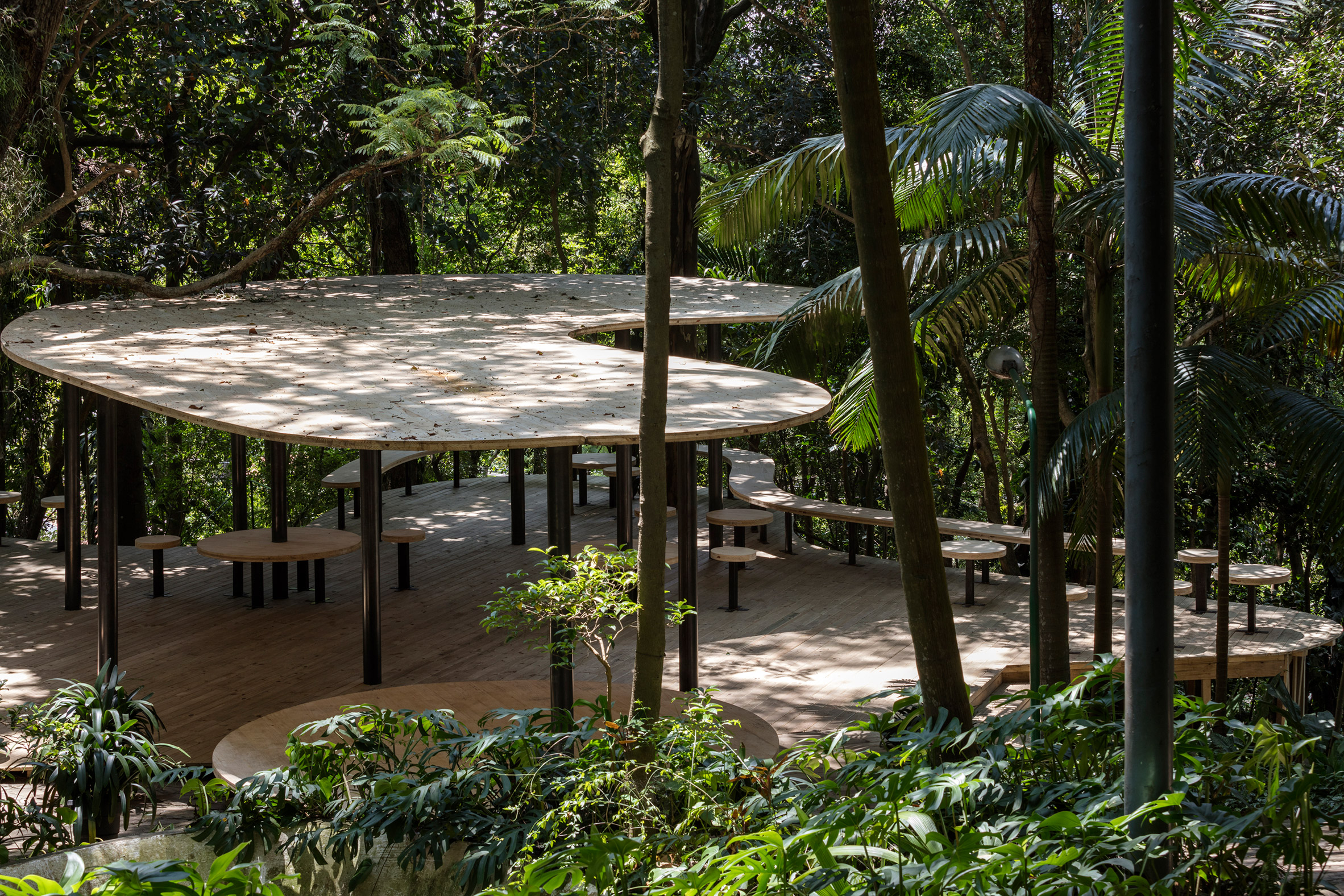 Curved pavilion nestles among gardens at Lina Bo Bardi's Glass House