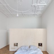 Ornate plasterwork ceilings hint at grand past of renovated 19th-century apartment in Vilnius