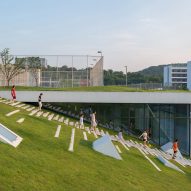 Hangzhou Cloud Town Exhibition Center by Approach Design has a green roof with a running track