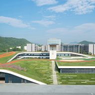 Hangzhou Cloud Town Exhibition Center by Approach Design has a green roof with a running track