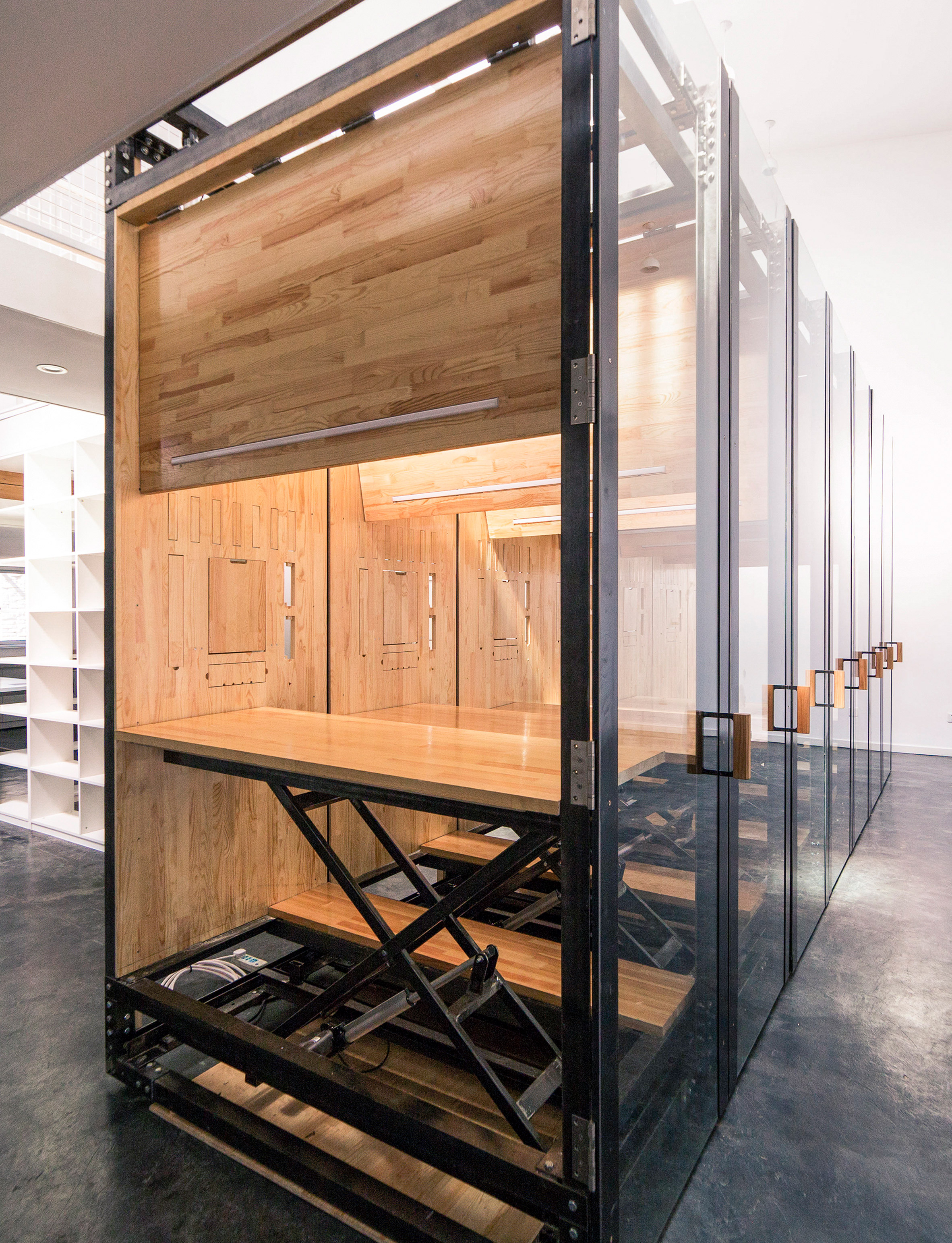 LUO Studio uses retractable desks to turn tiny office into presentation room