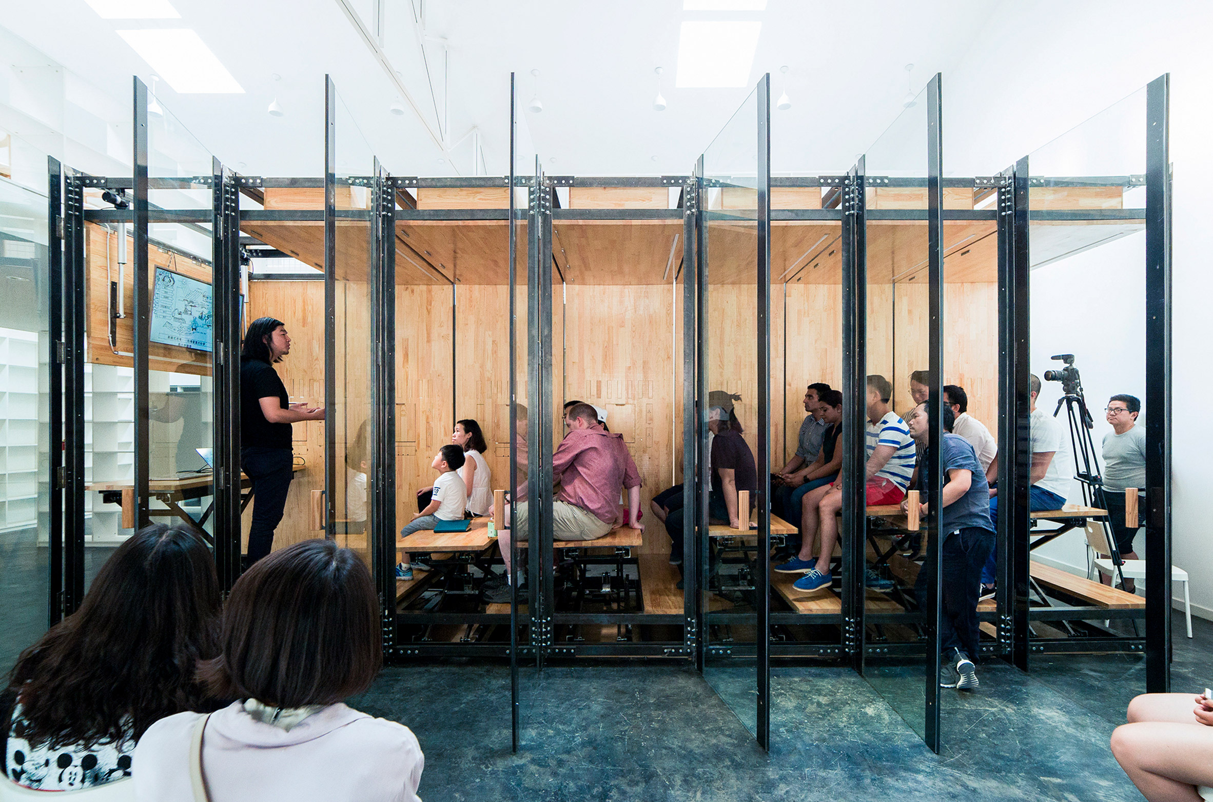 LUO Studio uses retractable desks to turn tiny office into presentation room