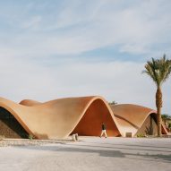 Oppenheim Architecture's sinuous concrete golf clubhouse mimics Jordan's desertscape