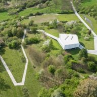 Robert Konieczny folds white concrete road around house in Poland