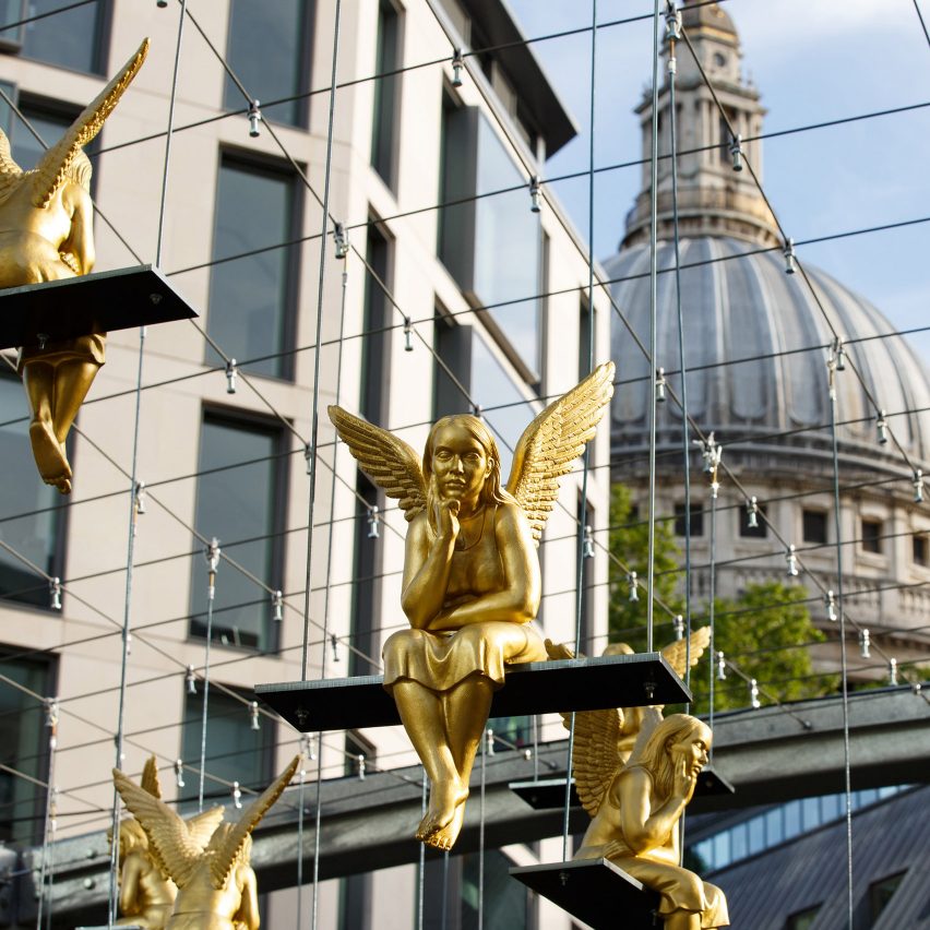 Lunch Break angels swing above commuters passing London's St Pauls