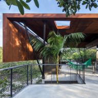 Laurent Troost Architects folds weathered steel roof over concrete house in Brazilian Amazon