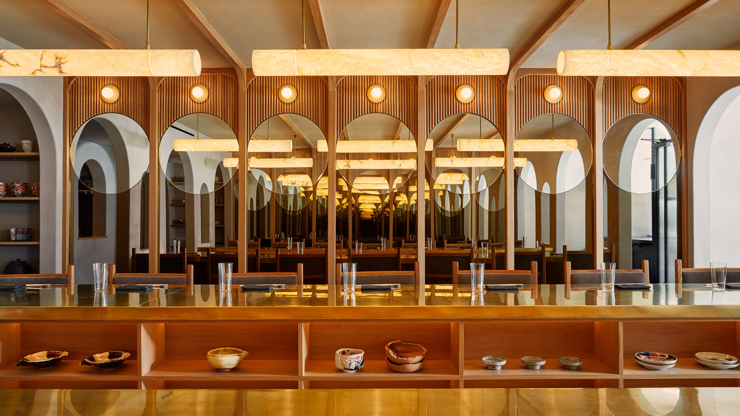 A wood-lined Japanese restaurant with alabaster lights