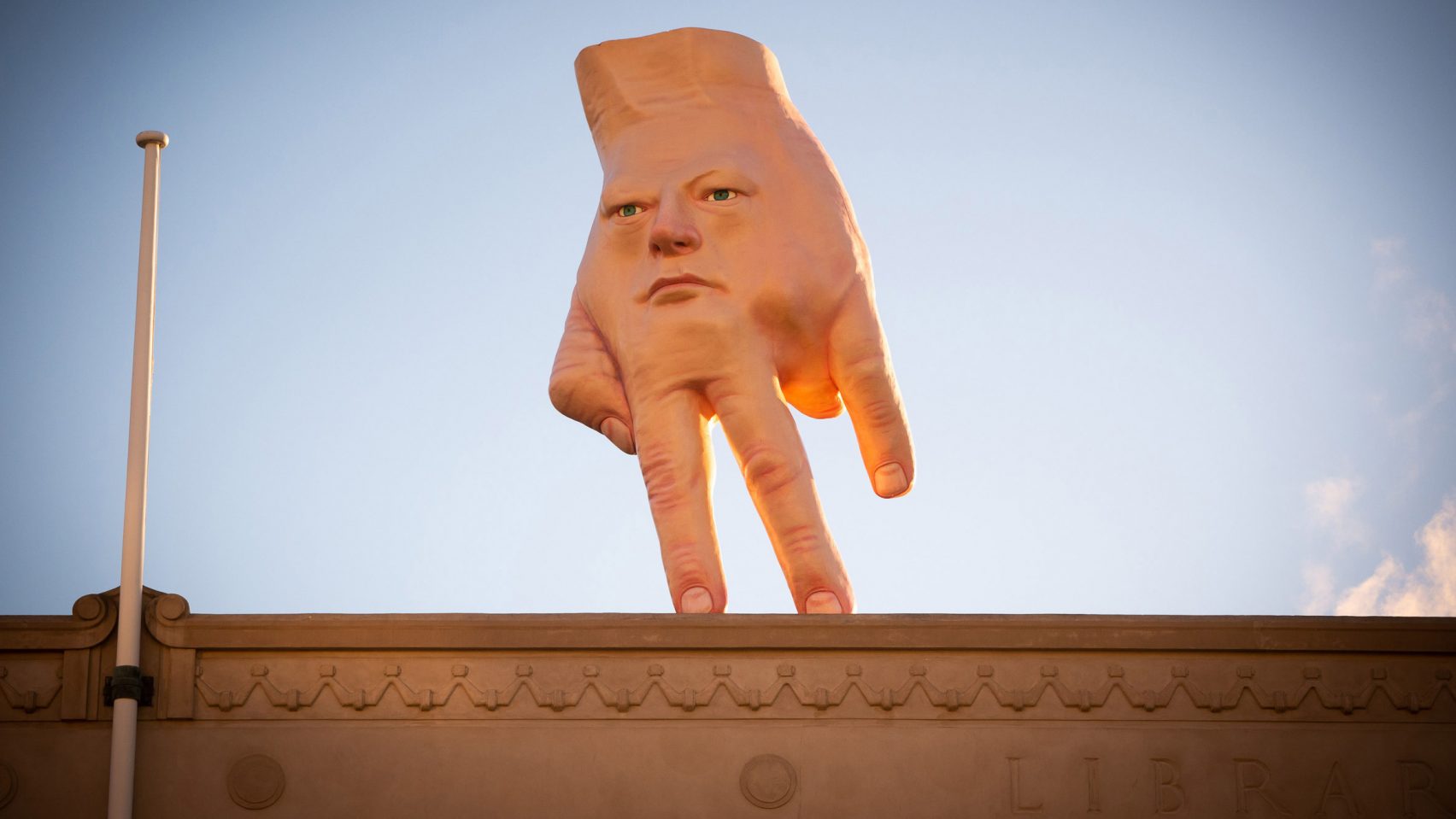 Giant Hybrid Face Hand Installed On Roof Of Art Gallery In Wellington