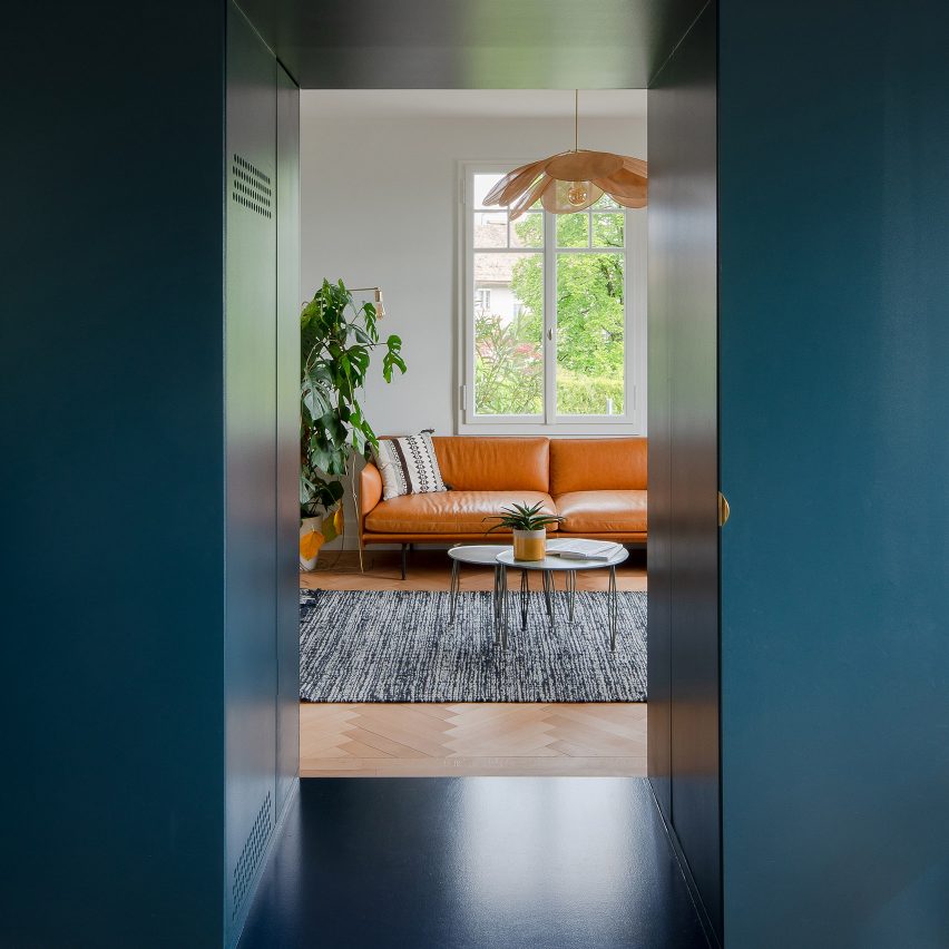 Bureau Brisson Architectes updates Swiss "hybrid" home with blue cabinetry