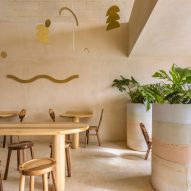 Stripy concrete planters punctuate Maku poke bowl restaurant in Cancun