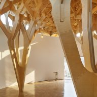 Entwined timber columns define structure of The House of Three Trees