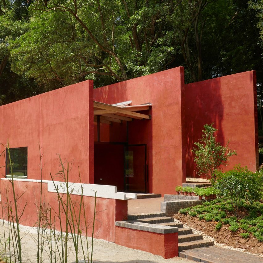 Red concrete walls enclose The Walls teaching restaurant for children in China