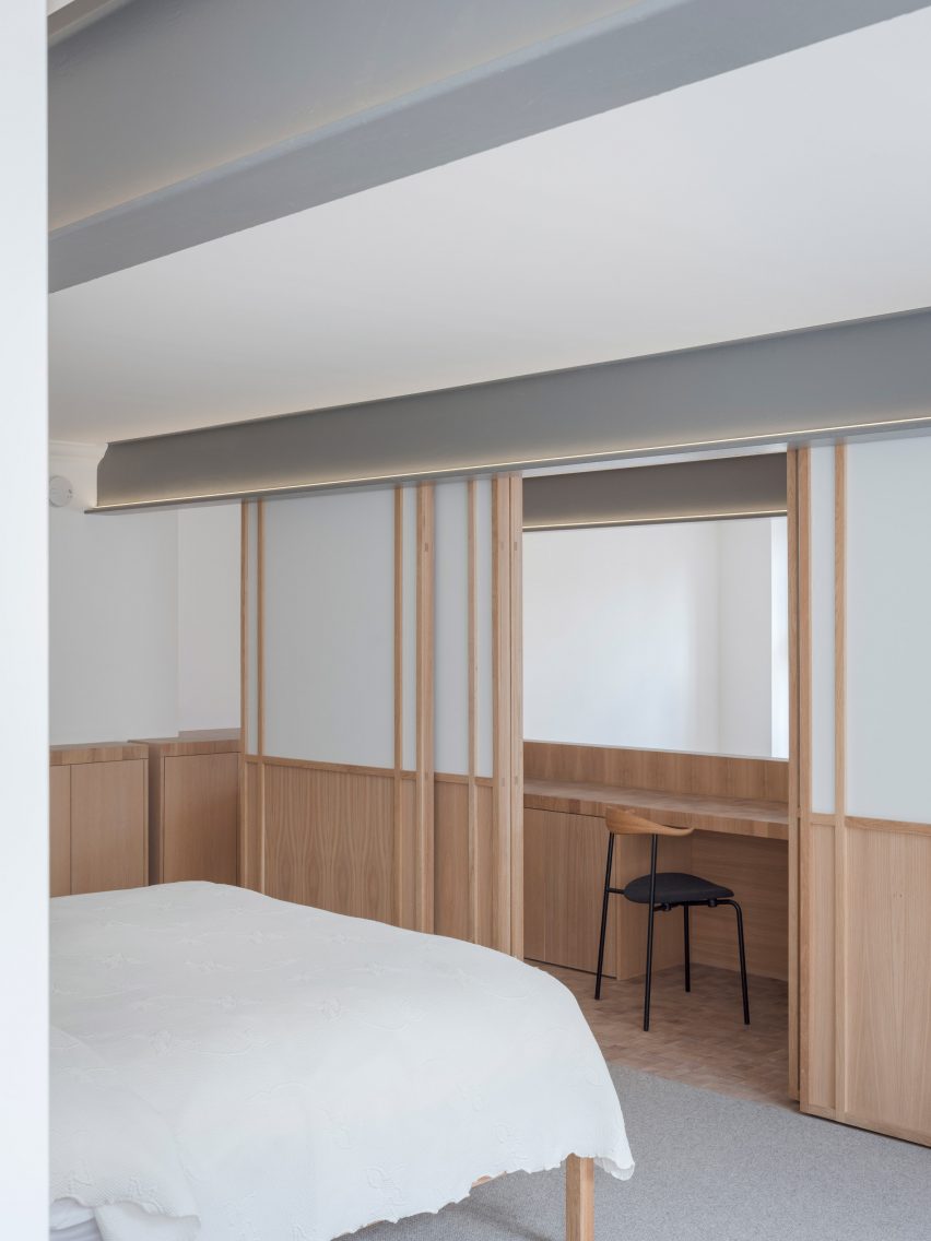 Wooden desk behind sliding doors in a bedroom at Apartment Block by Coffey Architects