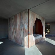 Pink marble core cuts through concrete interiors of Portuguese house