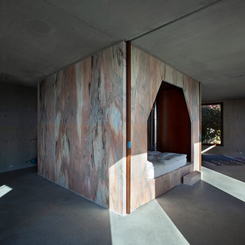 Pink marble core cuts through concrete interiors of Portuguese house