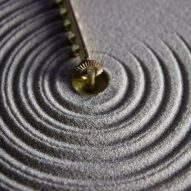 Studio Ayaskan designs clock that rakes sand to illustrate the ripples of time