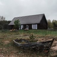 Two gabled black cabins form summer retreat on an Estonian beach