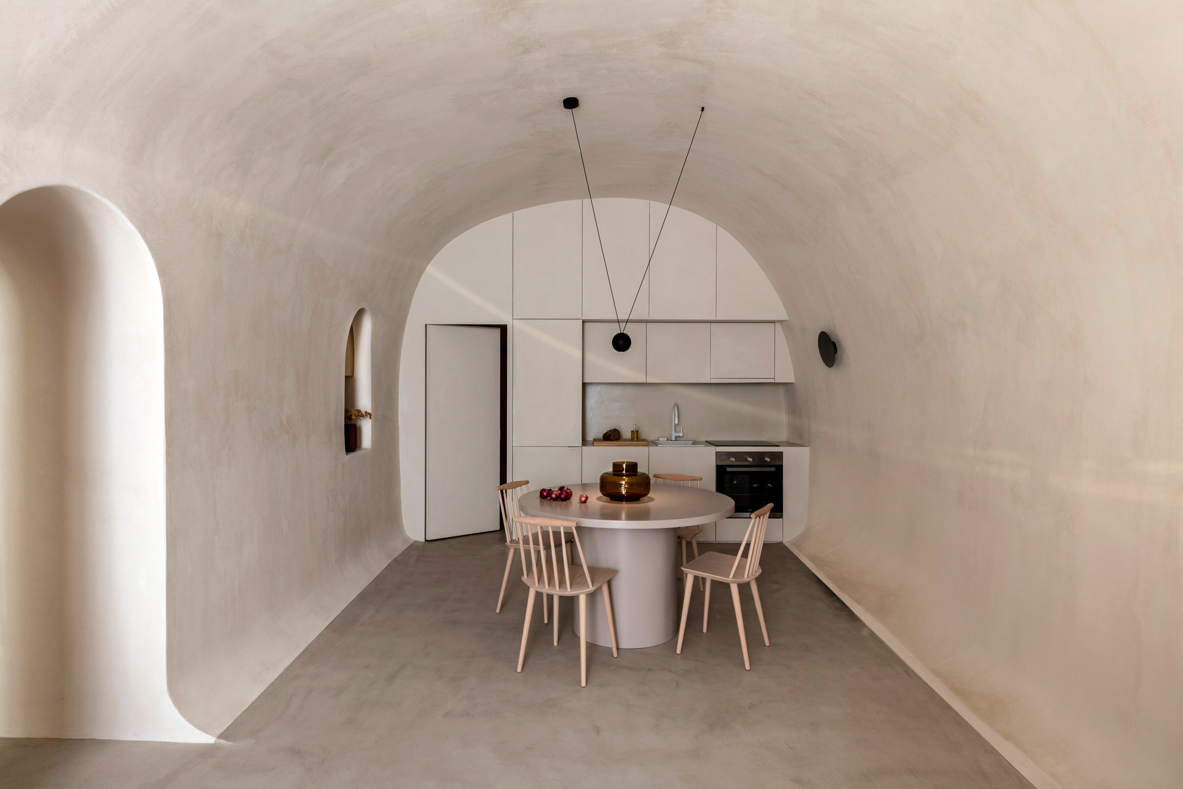 Holiday residence in a converted cave in Fira by Kapsimalis Architects
