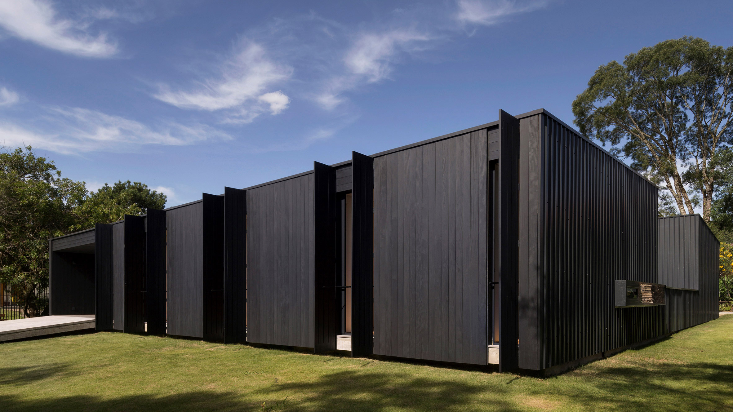 Dark walls conceal bright interiors within Casa de Lata by Sauermartins