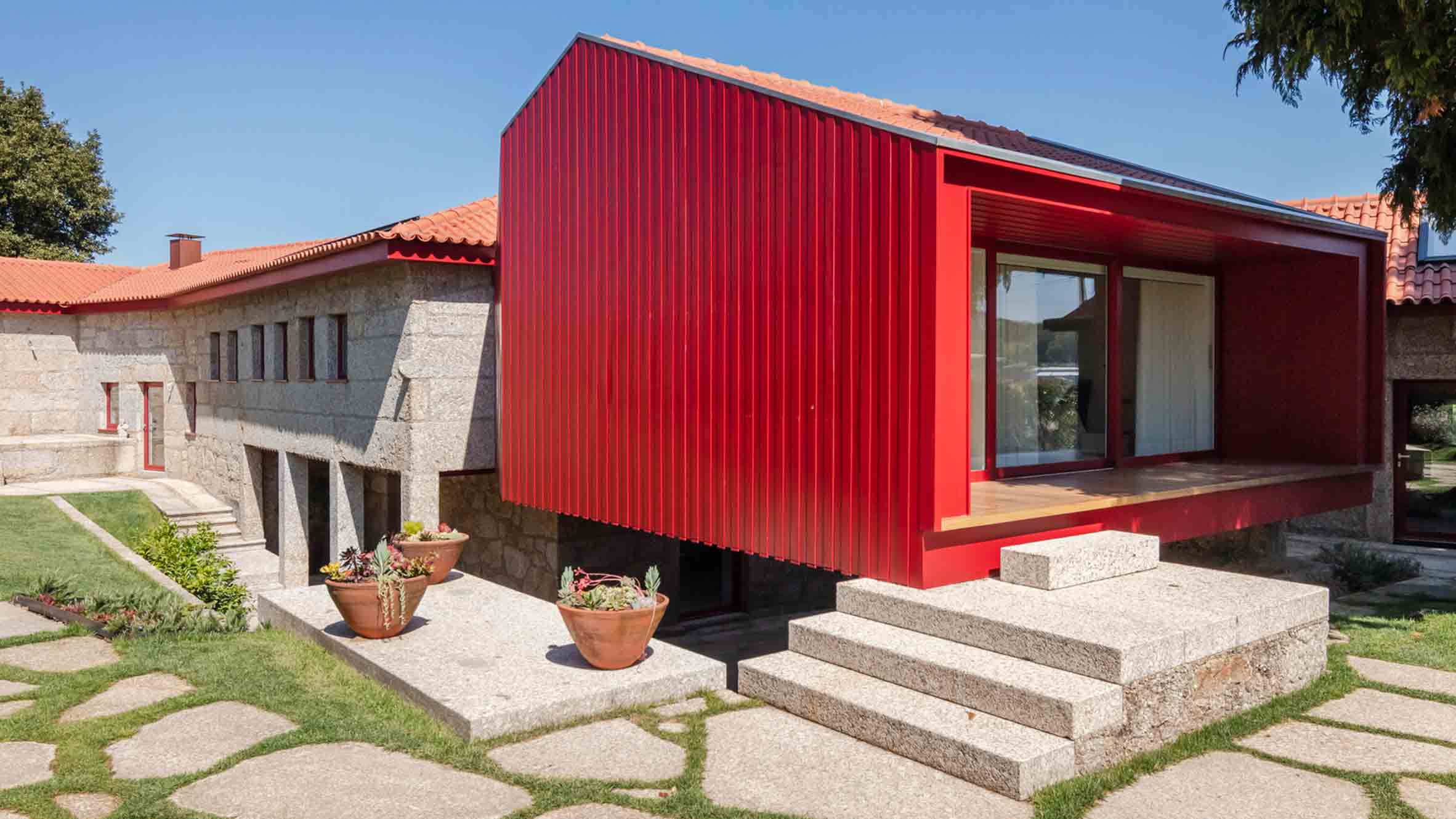 NOARQ renovates stone villa in Portugal with bright red details