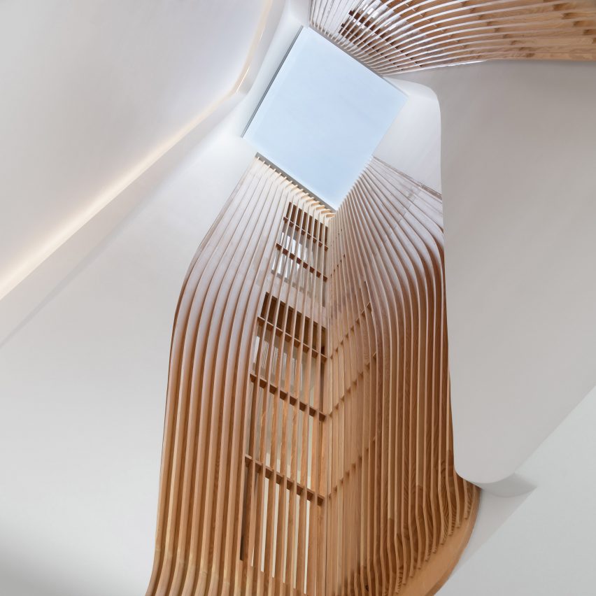 Flow Architecture lines stairwell of London house conversion with timber slats