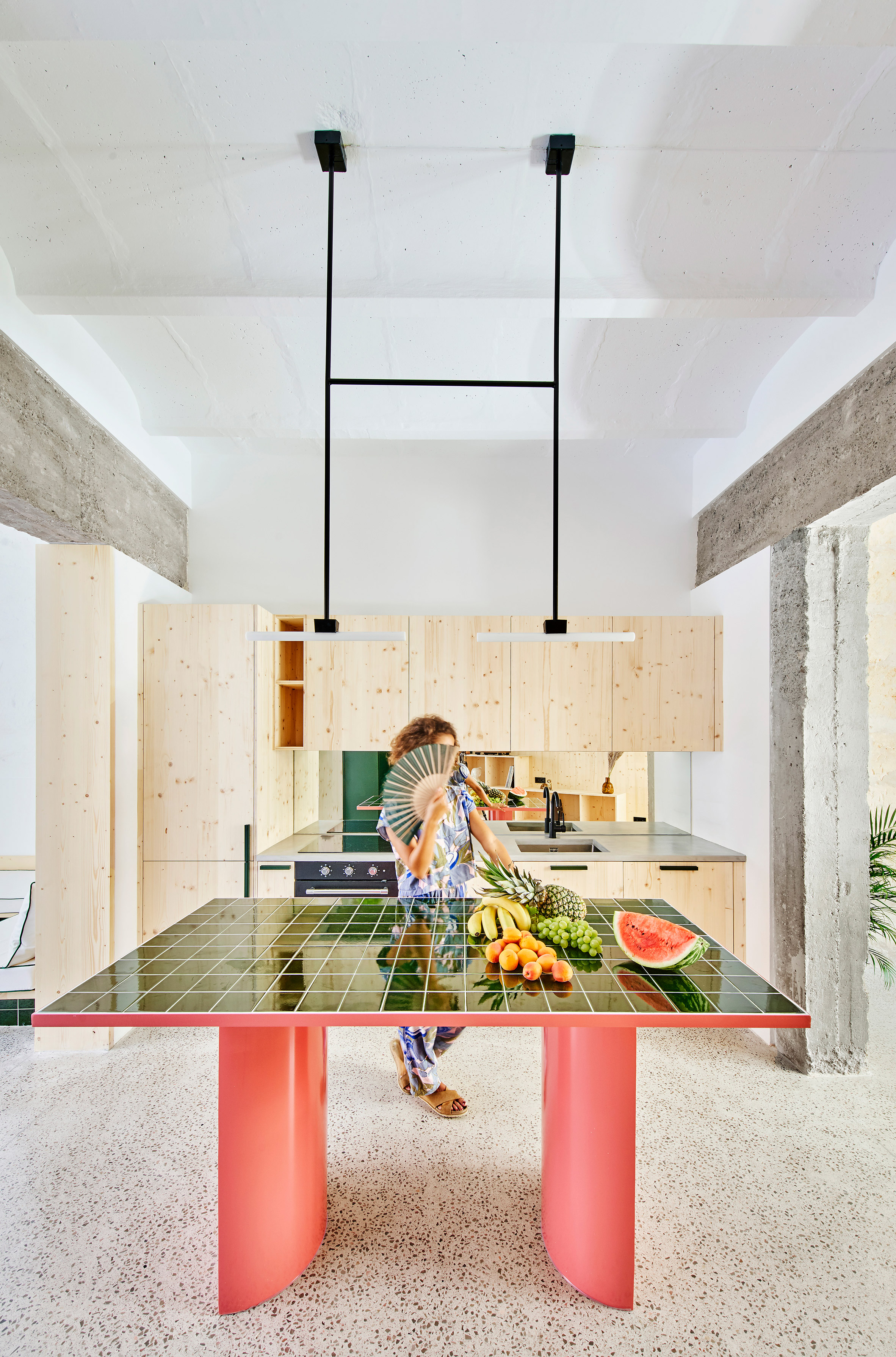 Bright pink and green kitchen island in Palma Hideaway by Mariana de Delás
