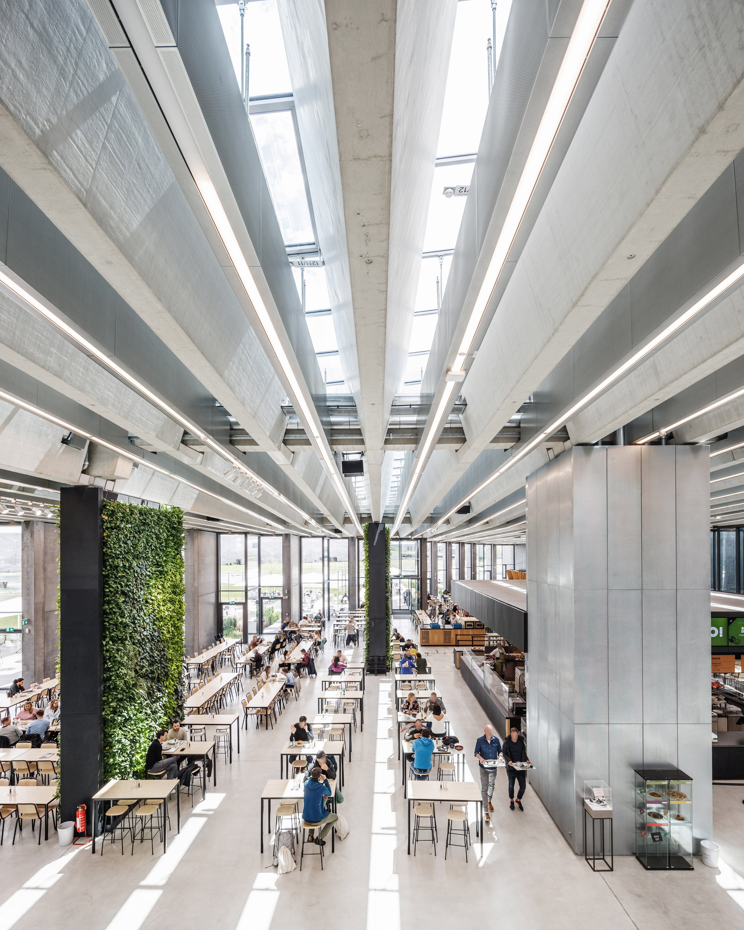 For tidlig omdrejningspunkt Gør gulvet rent Rhomboid roof brings light into COBE's Halftime building on the Adidas  campus