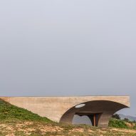 Cantilevering concrete roof emerges from Portuguese hillside house by Aires Mateus