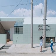 Green ceramic tiles cover extension of a house in rural China