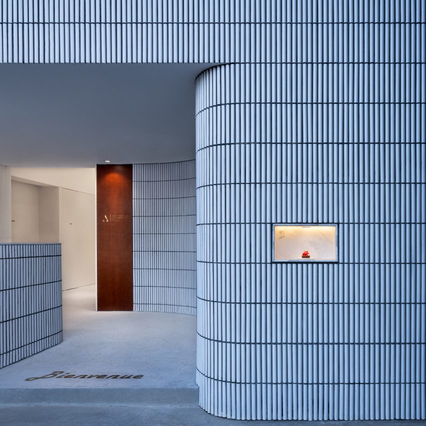 Curved tiled wall guides customers inside Hangzhou's Angelot patisserie