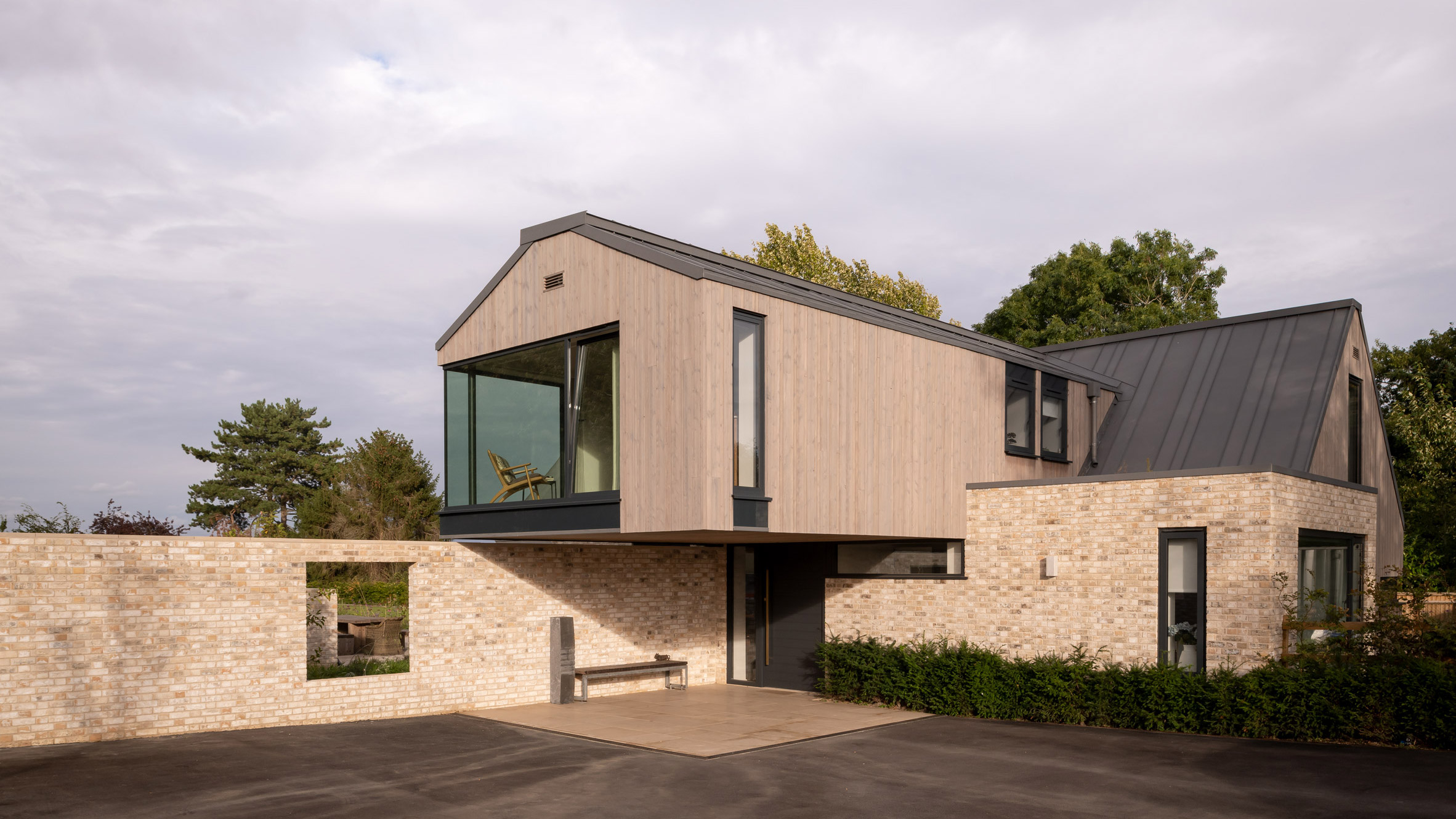Weathered Timber Cladding Covers Shed Like Field House In Rural England
