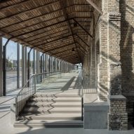 Steel and glass exoskeleton transforms abandoned warehouse into concert venue