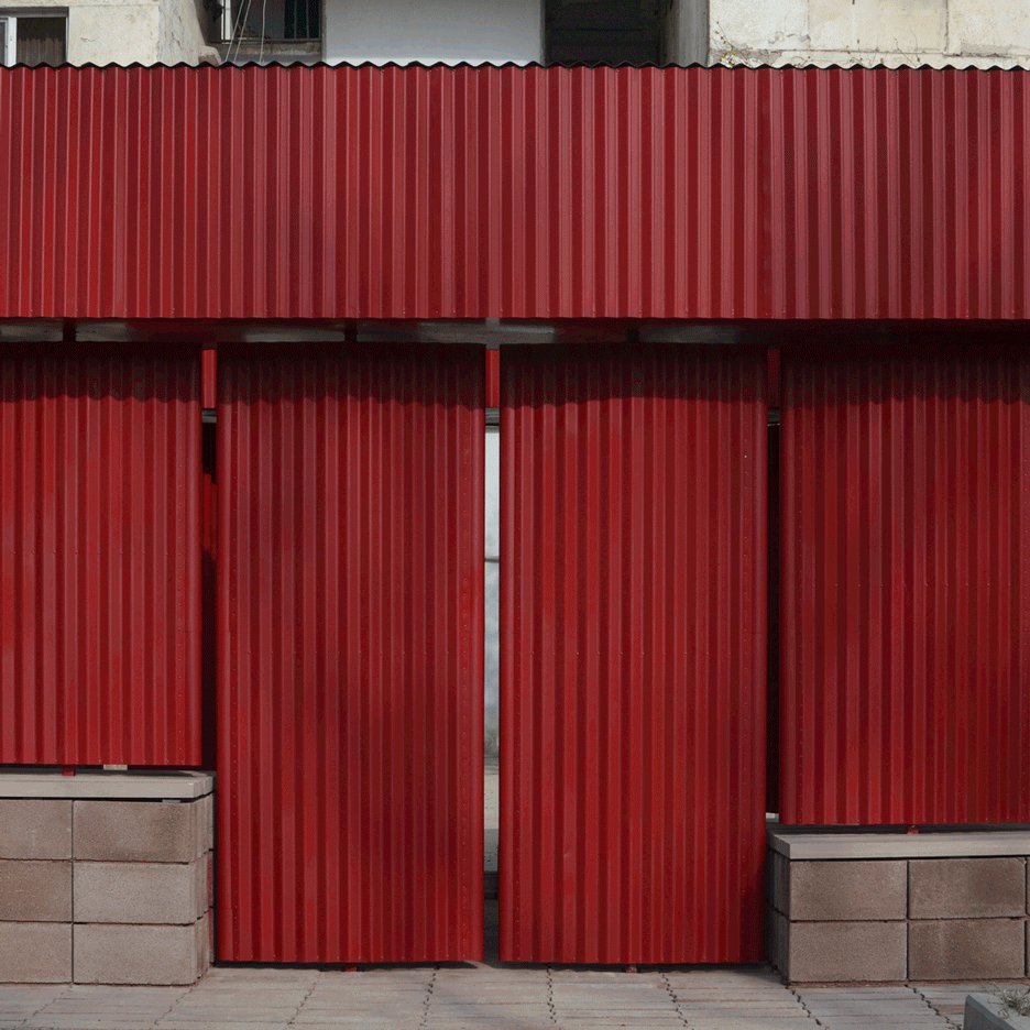 Pivoting red metal panels form walls of neighbourhood pavilion in Tblisi