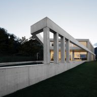 Colonnade extends from concrete house on an old vineyard in Switzerland