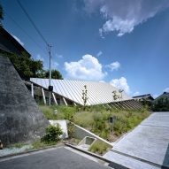 Large sloping roof shelters House in Gakuenmae by FujiwaraMuro Architects