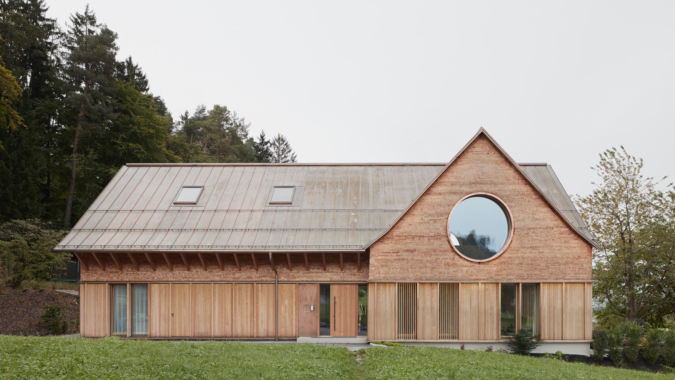 innauer matt architekten completes house with three eyes in rural austria