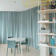 Azab swaps partitions for pale-blue curtains inside Bilbao family home