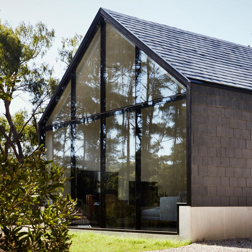 House clad in slate shingles by Telha Clarke features glazed gable end