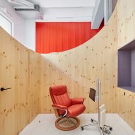 Impress dental clinic in Barcelona features smile-shaped timber partitions