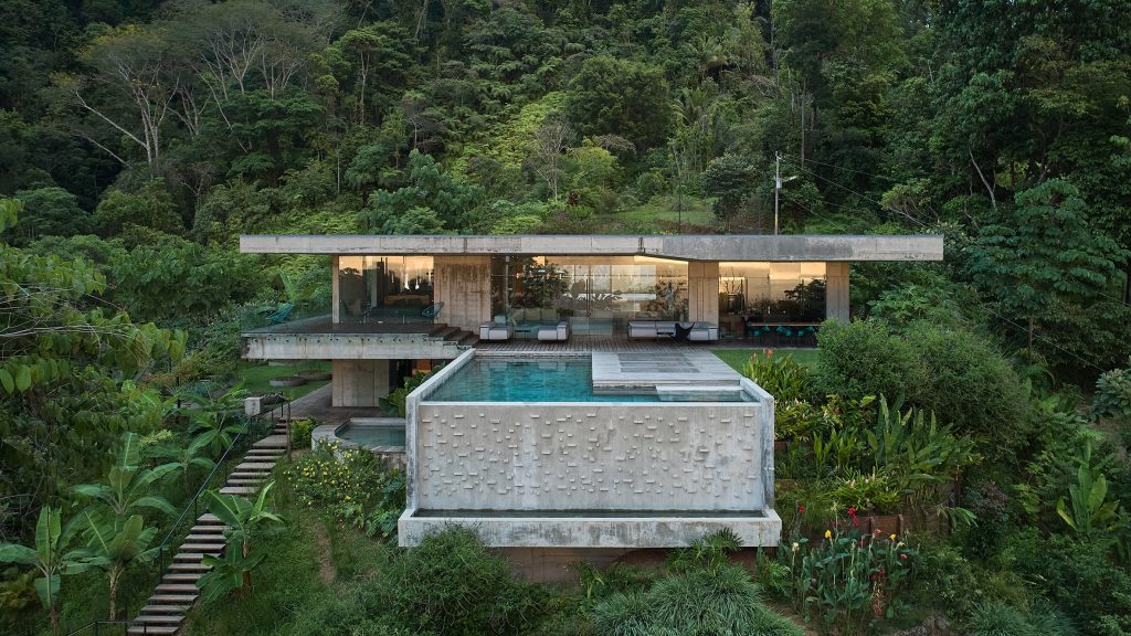Concrete swimming pool protrudes from holiday home in Costa Rican jungle