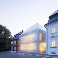 Translucent glass house built alongside historic buildings for Lasvit's Czech Republic HQ