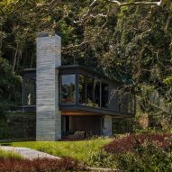 Olson Kundig Rio House is elevated on chunky concrete columns in Brazilian rainforest