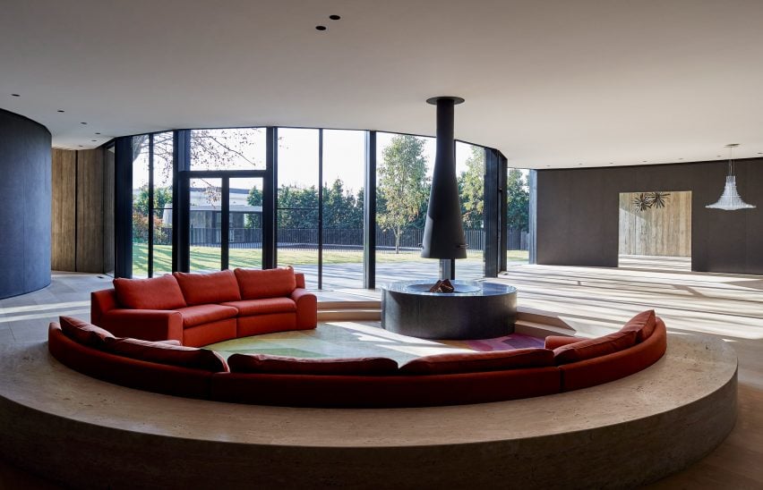 Sunken seating area with suspended fireplace in Towers Road House by Wood Marsh