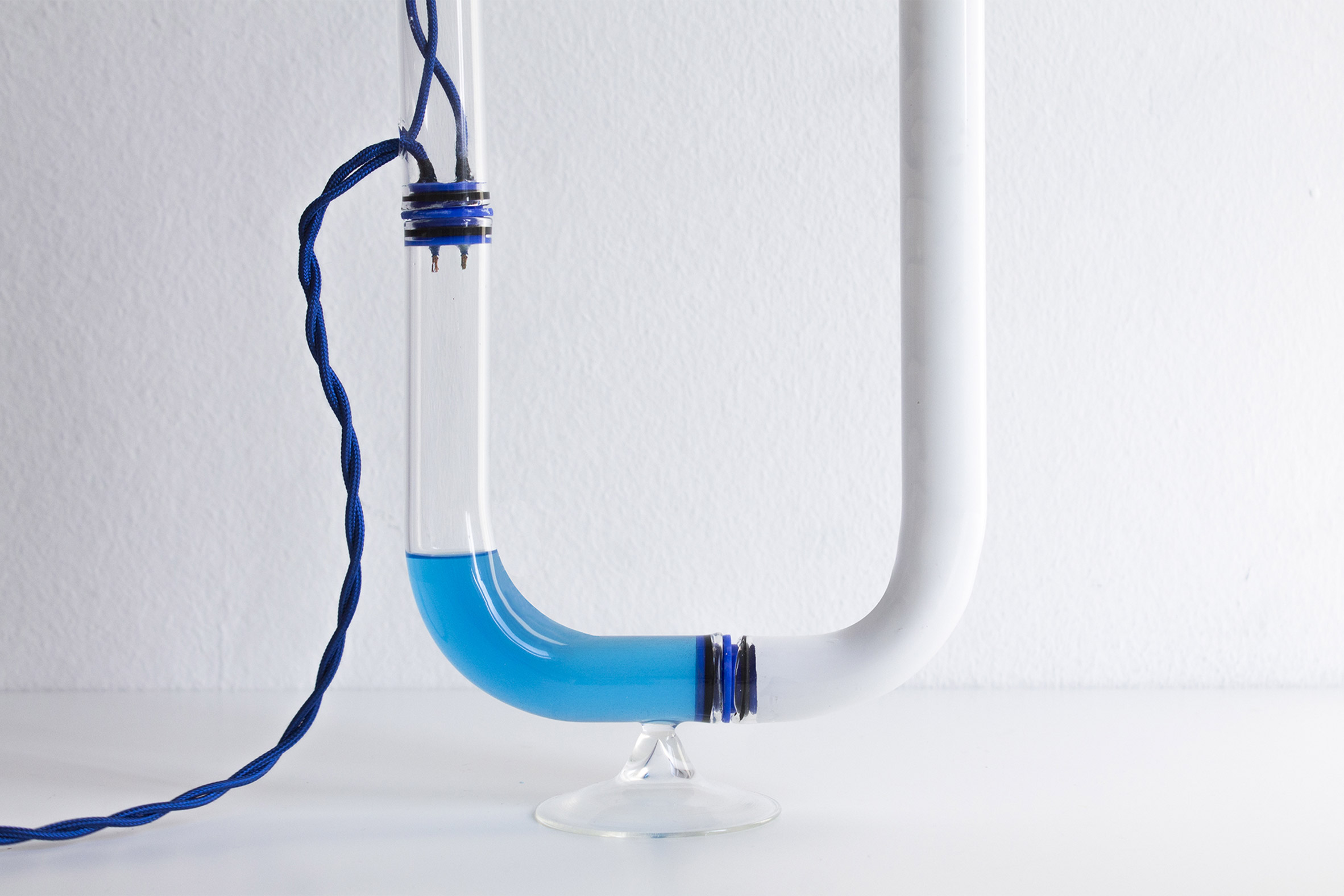 Tubular Circuiti Liquidi lamp uses blue liquid to activate light