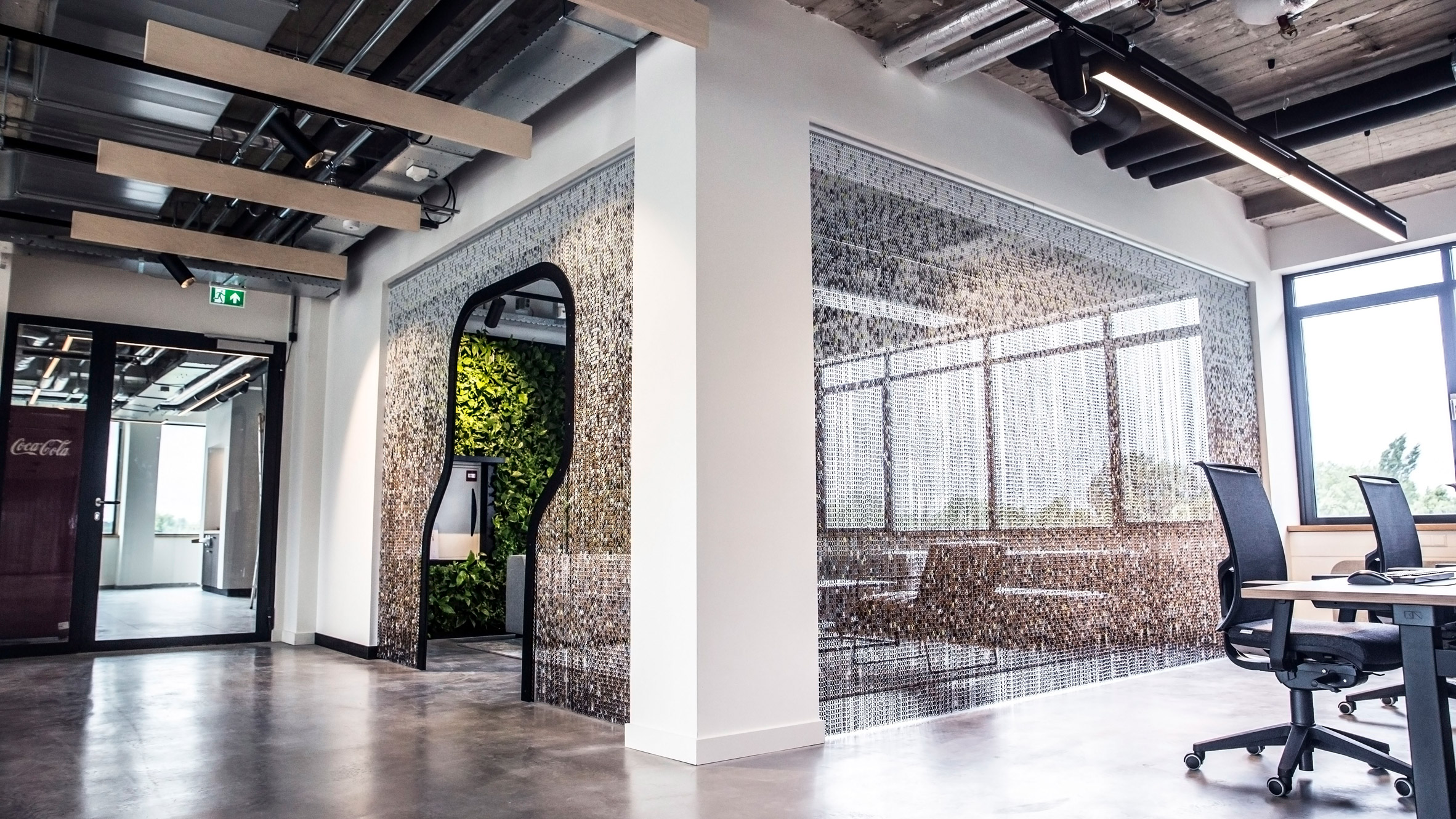 Kriskadecor's chain-link partitions aid social distancing in shared interiors