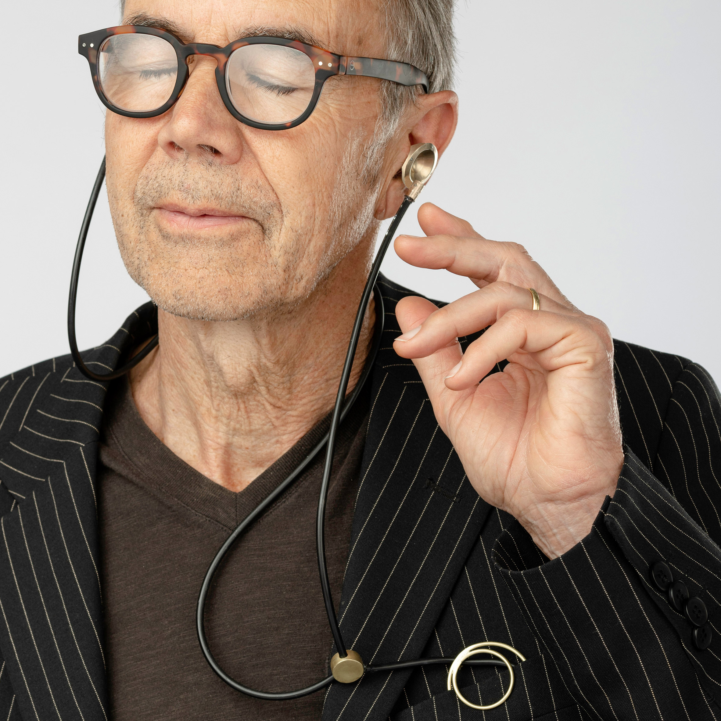 Person with hearing aid jewellery in ears