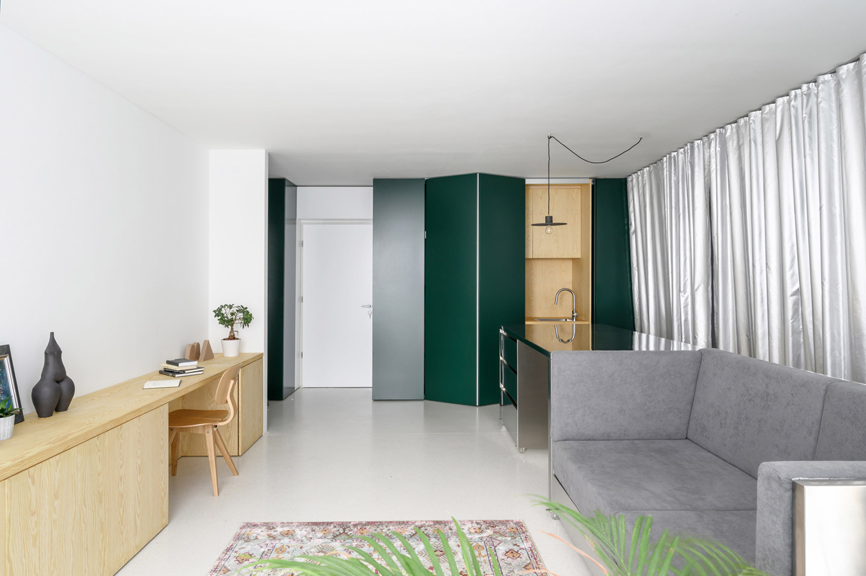 Ljubljana apartment features mobile furnishings and silver curtains