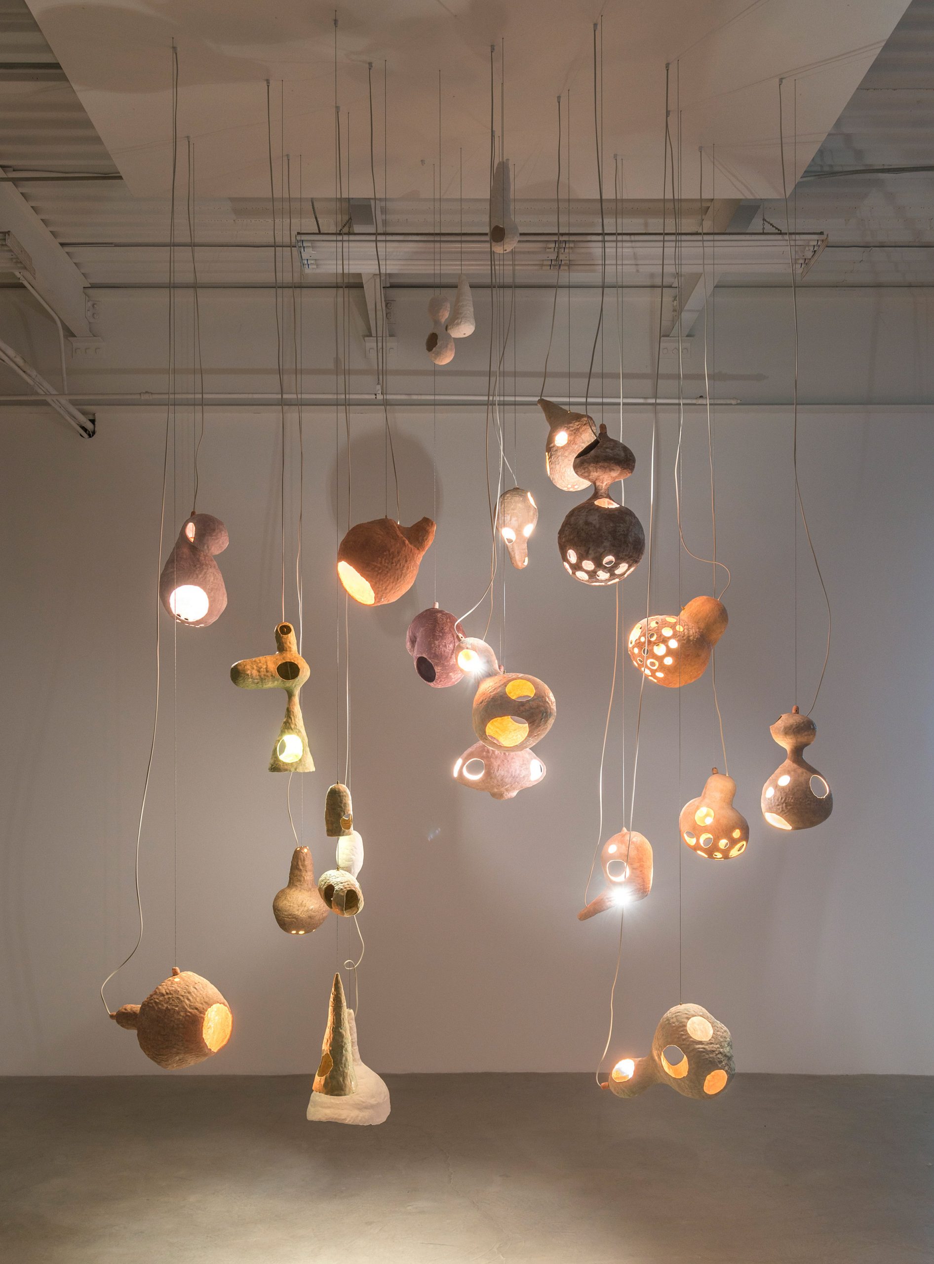 Yuko Nishikawa forms "floating" amorphous lights from shells of clay and paper