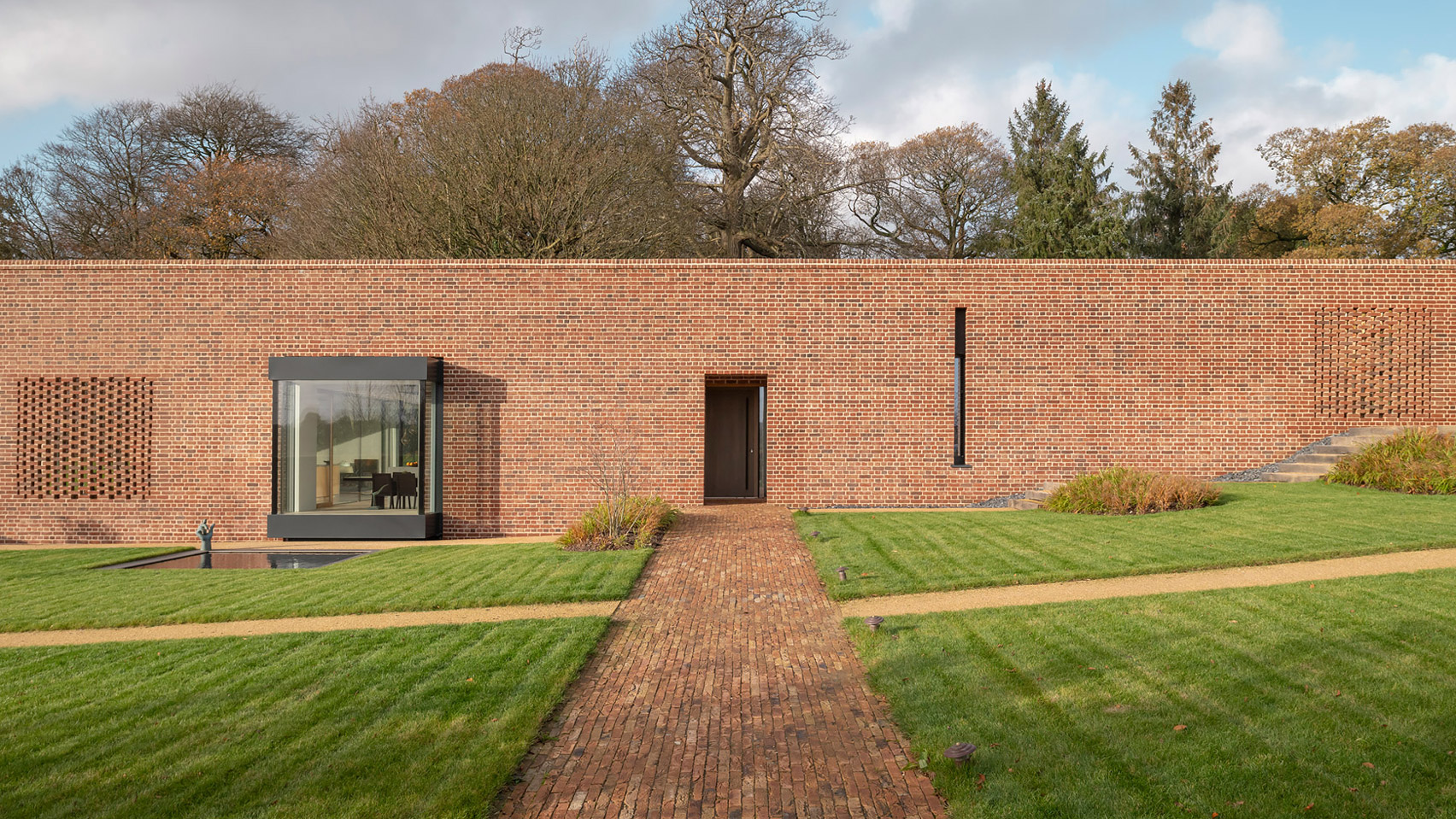 Linear Brick Wall Conceals Earthy And Tactile Interiors Of Devon Passivhaus