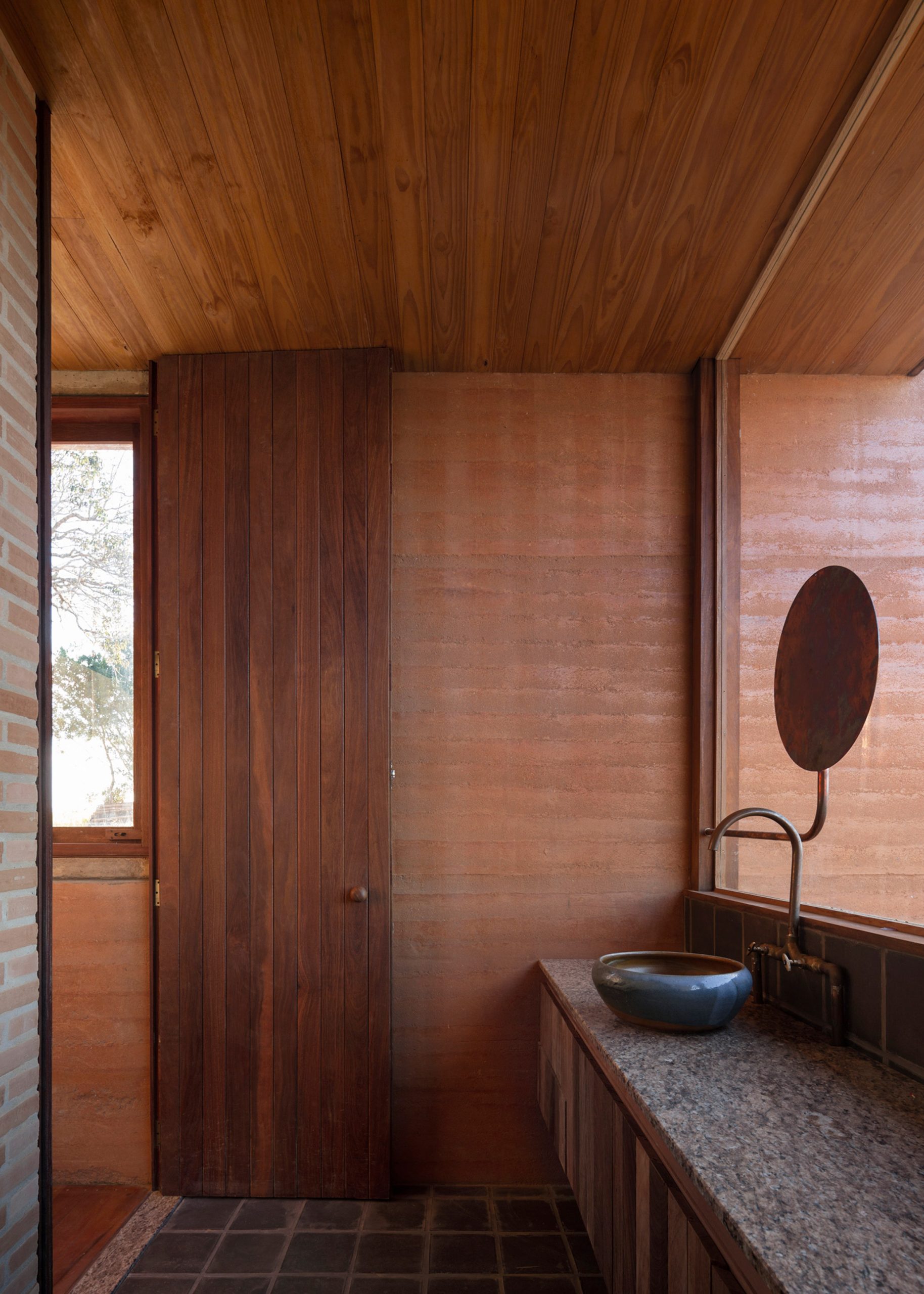 House in Cunha by Arquipelago with chocolate brown walls